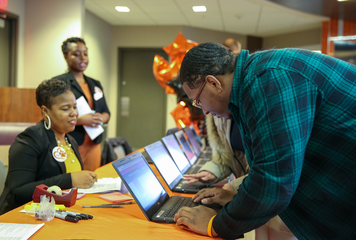 Tiffany Rose checking in attendees of Job and Internship Fair.